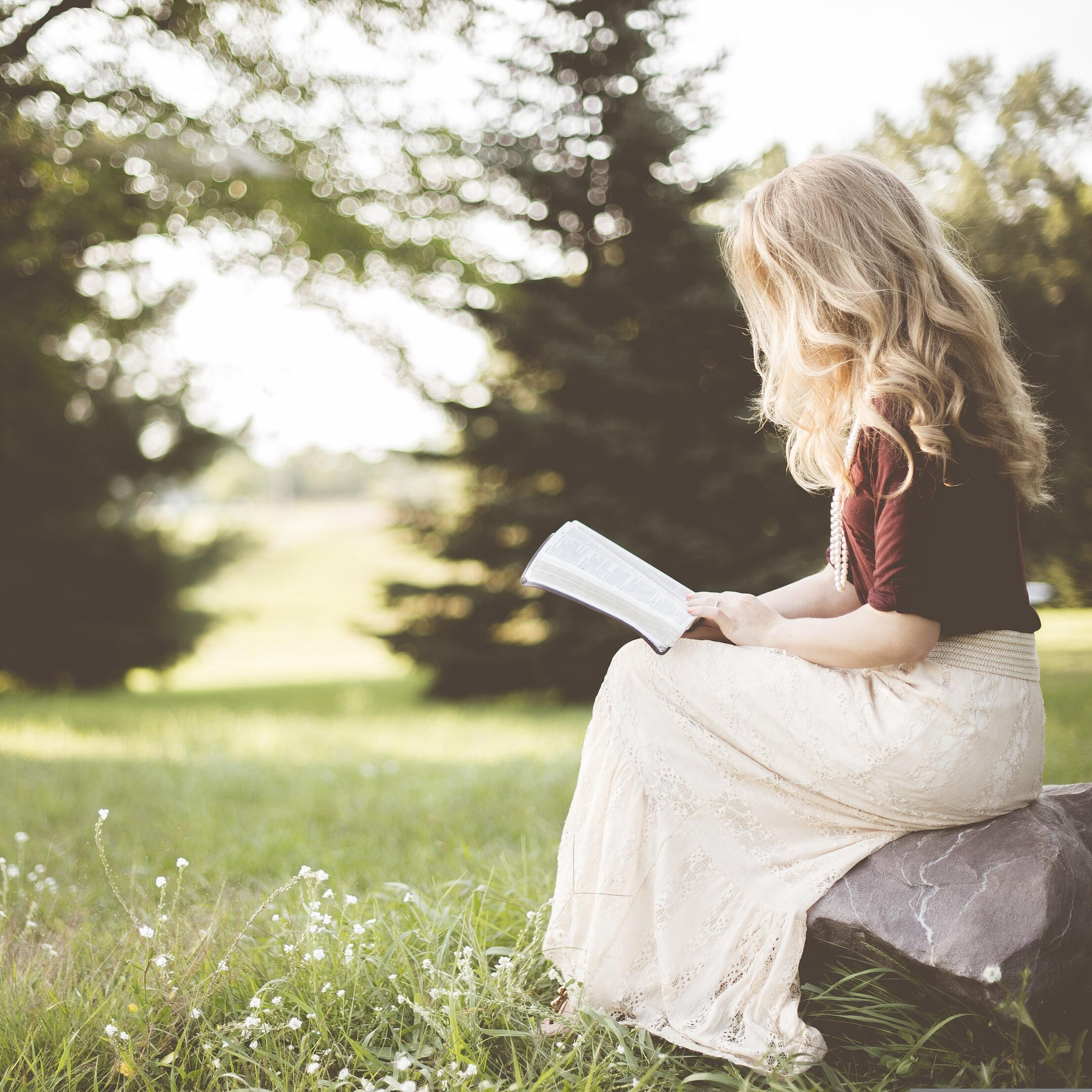 girl reading in meadow